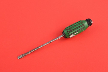 Green and black handeled screw driver.