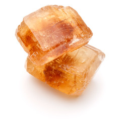 Brown caramelized lump cane sugar cube isolated on white backgro