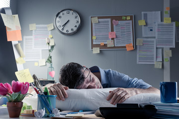 Businessman sleeping in the office overnight