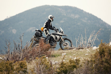 Man Driving a Motorcycle in Nature