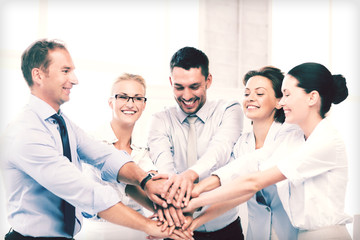 business team celebrating victory in office