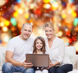 smiling family with laptop