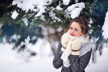 beautiful blonde woman walking outdoors under snowfall