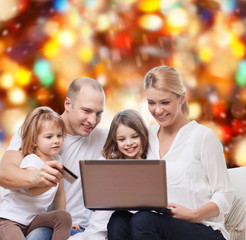 happy family with laptop computer and credit card