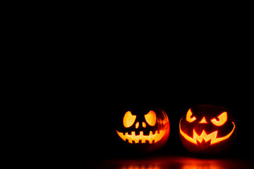 Scary Halloween pumpkins isolated on black with space for text