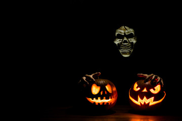 Scary Halloween pumpkins and skull with space for text