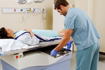 Technician inserting plate for x-ray