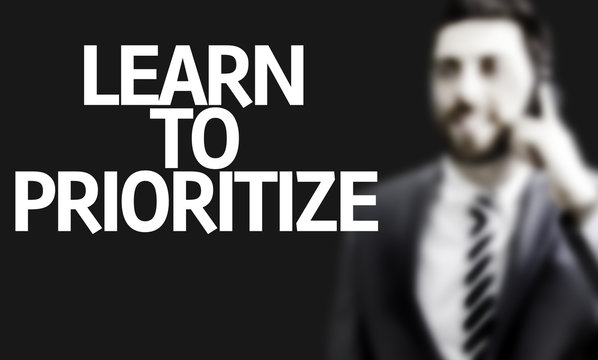 Business man with the text Learn to Prioritize