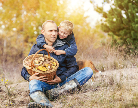 Father with son rest in autumn forest