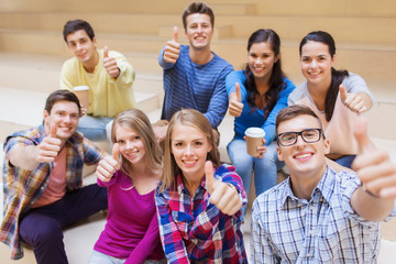 group of smiling students with paper coffee cups