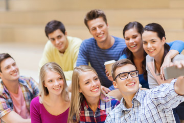 group of students with smartphone and coffee cup