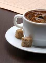 Cup of coffee and newspaper