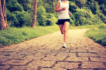 young fitness woman runner running on trail