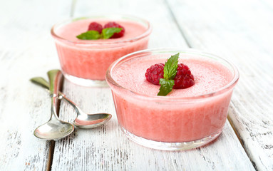 Delicious berry mousse in bowls on table close-up