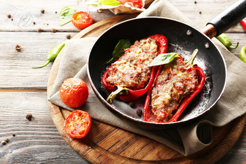 Delicious stuffed peppers in frying pan on table close-up