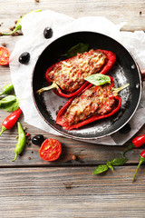 Delicious stuffed peppers in frying pan on table close-up
