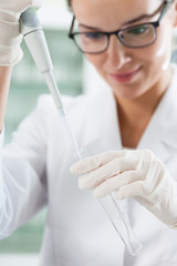 Lab technician using pipette