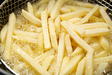 French fries in deep fryer, closeup