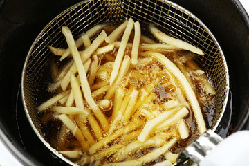 French fries in deep fryer, closeup