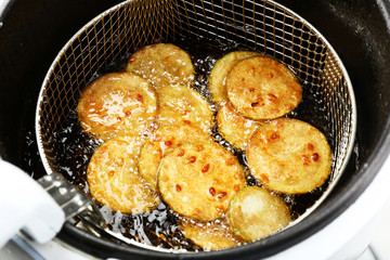Zucchini in deep fryer, closeup