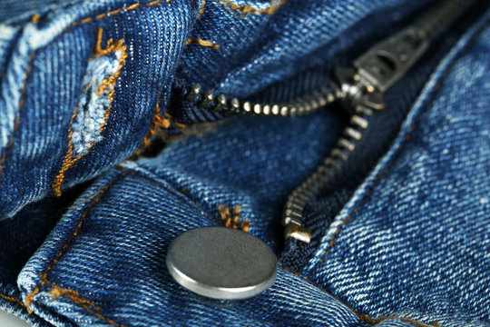 Zipper and button on clothes close up