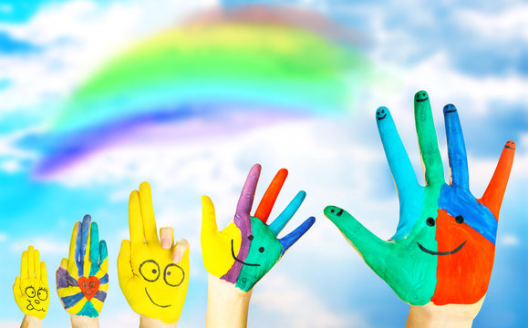 Painted hands on sky background