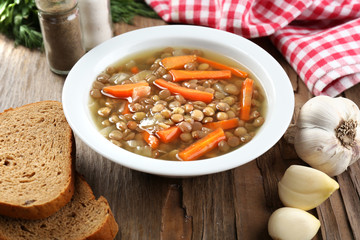 Delicious lentil soup on table close-up