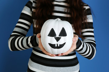 Woman holding decorative pumpkin, close-up