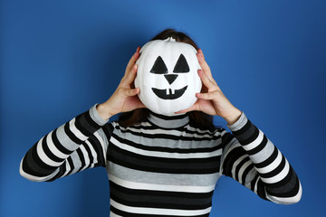 Woman holding decorative pumpkin, close-up