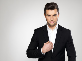 Fashion young businessman in black suit