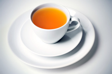 Herbal hot tea in ceramic cup on plate