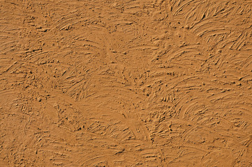 The texture of  light-brown walls painted large erratic strokes