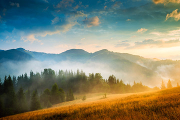 Amazing mountain landscape with fog and a haystack - obrazy, fototapety, plakaty