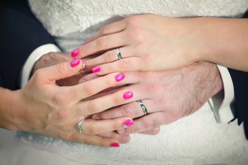 Wreathed hands with the ring on the finger of the happy couple