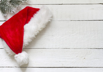 Obraz na płótnie Canvas Santa Claus hat on white wooden boards christmas background
