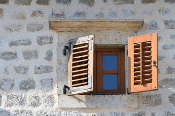 Wooden window with shutters close-up in an old house