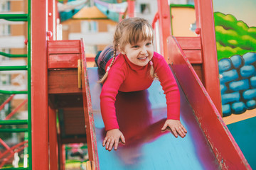 Fototapeta na wymiar Little girl on the playground.