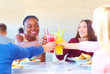 multiracial female friends having fun in restaurant