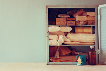 Fototapeta na wymiar Vintage antique first aid kiton wooden table. filtered image