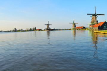 Fototapeta na wymiar Dutch windmills in the summer and a lake