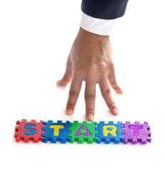 Business man hand start up with sigsaw colorful text, business c