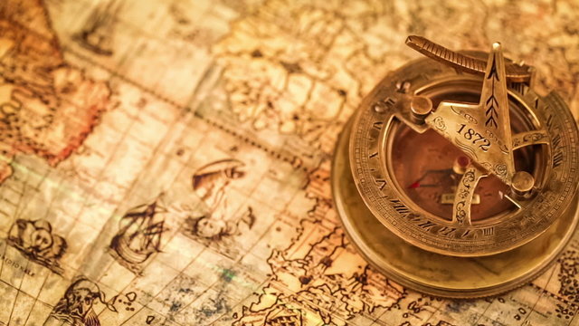 Vintage still life. Vintage compass lies on ancient world map