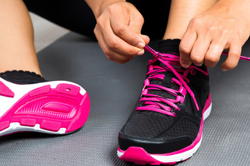 Woman tying her sports shoes ready to run