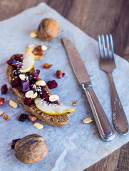 sandwich with vegetables, nuts and a pear on rye bread