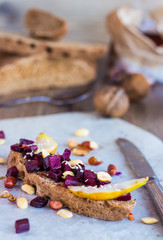 sandwich with beets, walnuts and pear on black bread
