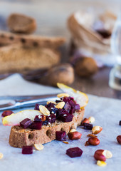 sandwich with beets, walnuts and pear on black bread