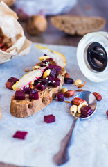 snack sandwich with roasted beets, nuts, pear and sesame