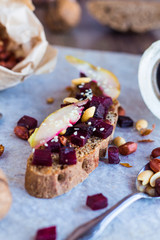 snack sandwich with roasted beets, nuts, pear and sesame