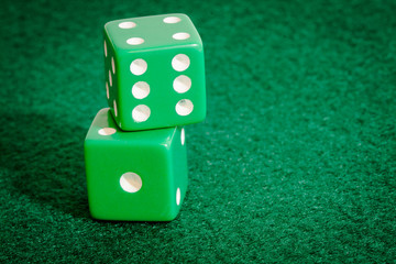 Green Dice on poker table