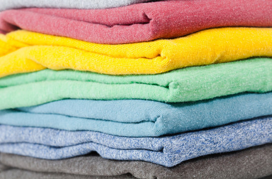 Clean stacked and Folded colored shirts close up where 
